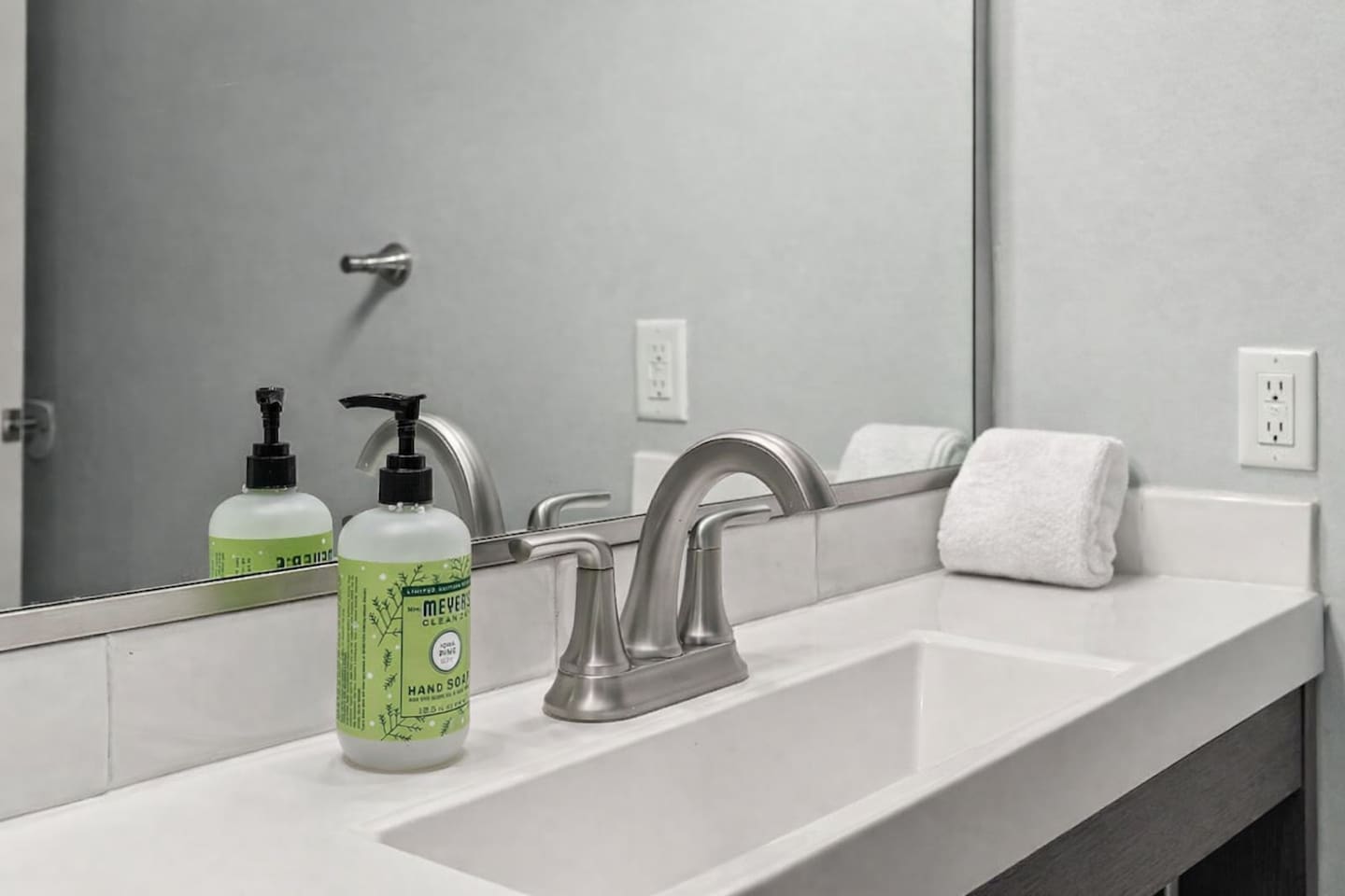 Bright and functional bathroom layout with modern flooring, neutral tones, and ample open space.