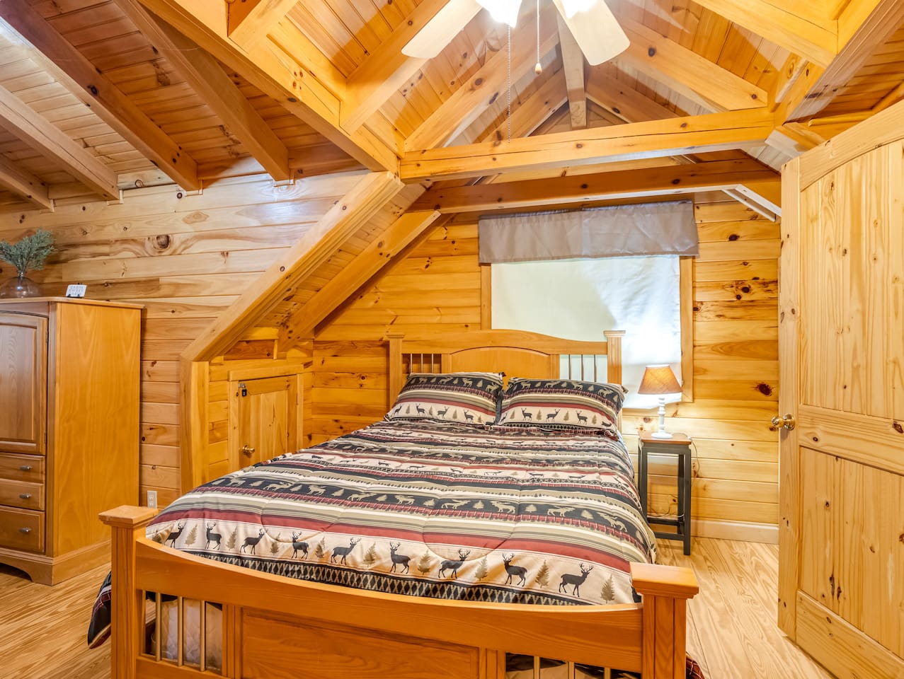 Bedroom on the third level of the property features a comfortable double bed, private bathroom, and plenty of storage space
