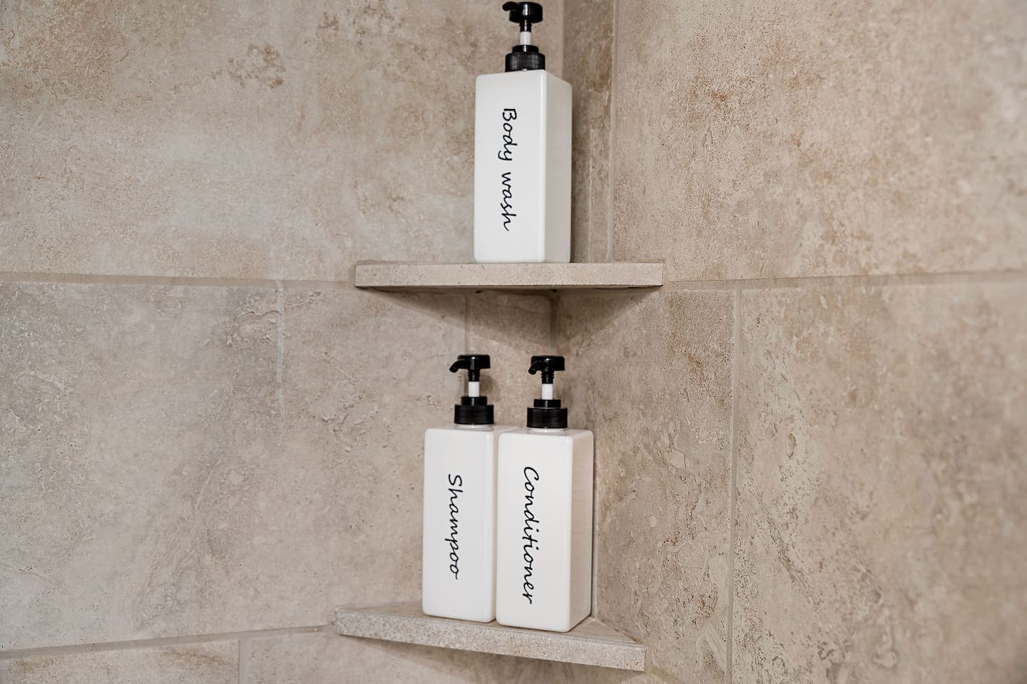 Refresh in the shower with provided body wash, shampoo, and conditioner. The neatly labeled bottles offer convenience and a touch of luxury.