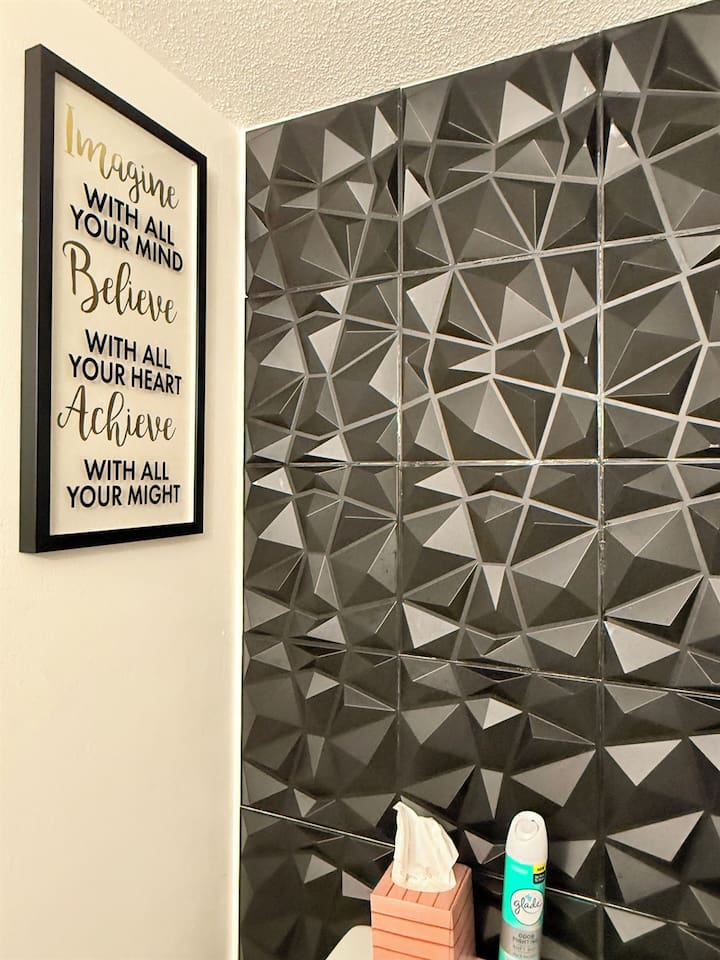 Uplifting wall quote paired with textured tile — small details that make a big impression. 