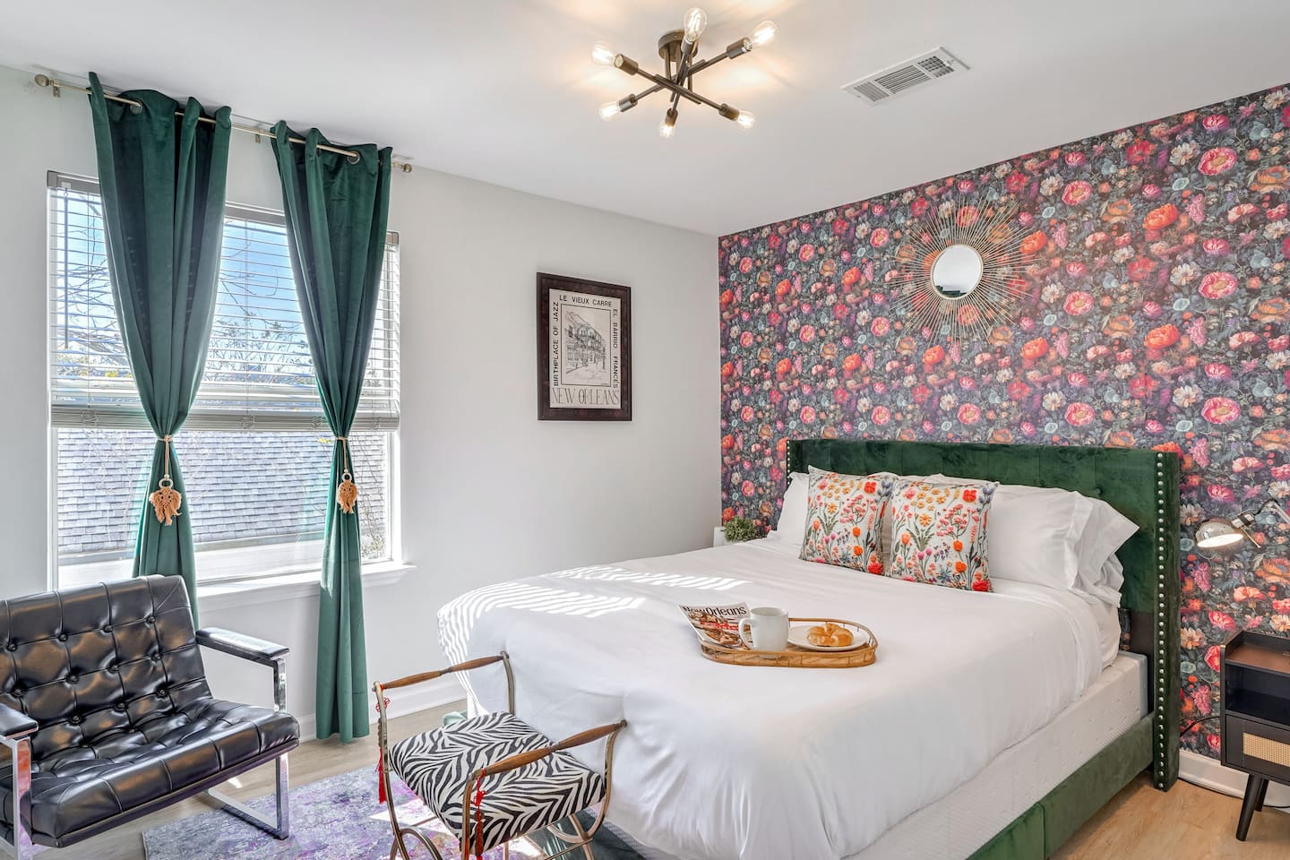 Recharge in the 'Green Room,' with a comfy queen bed, luxurious bedding, and unique local art 