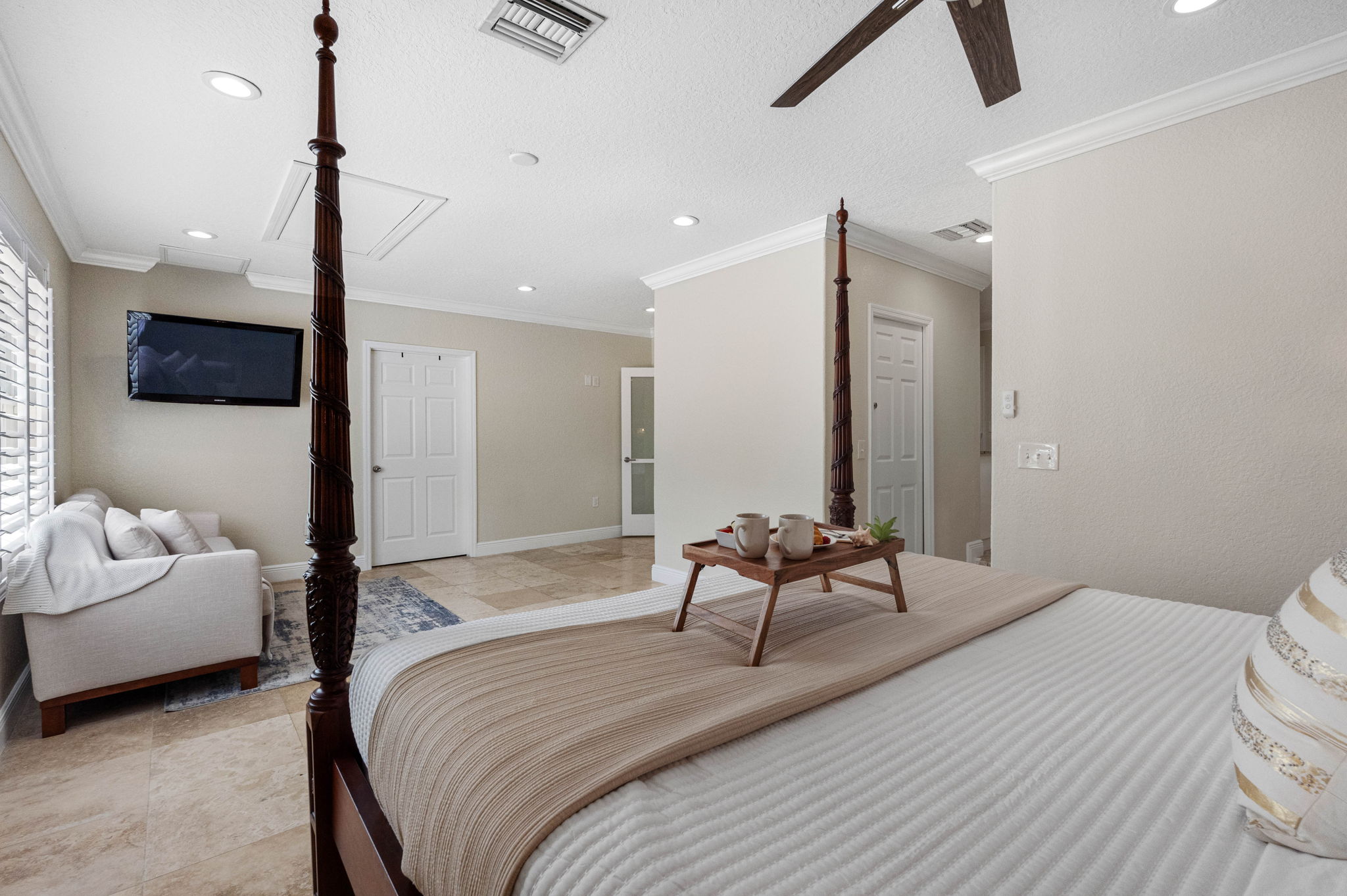 A spacious layout offers both a sleeping area with a statement bed and a comfortable sofa for additional lounging space.