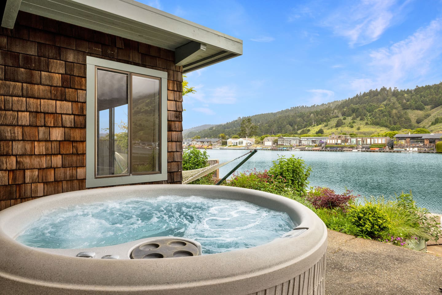 - Private hot tub with bubbling jets overlooking a scenic waterfront view  
- Perfect spot to relax while enjoying the fresh air and peaceful setting  
- Positioned just steps from the home for convenience and easy access  
