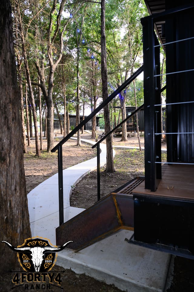 Entrance into your cabin and view of the Barn Owl cabin and bathhouse where you have your own private bathroom.