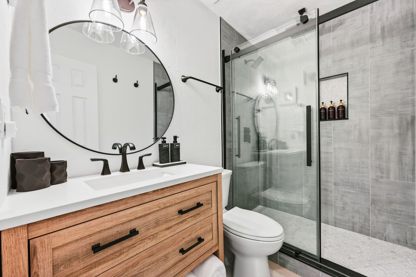 Relaxing full bathroom with walk-in shower, plush towels, and complimentary shampoo, conditioner, body wash, lotion, and hand soap