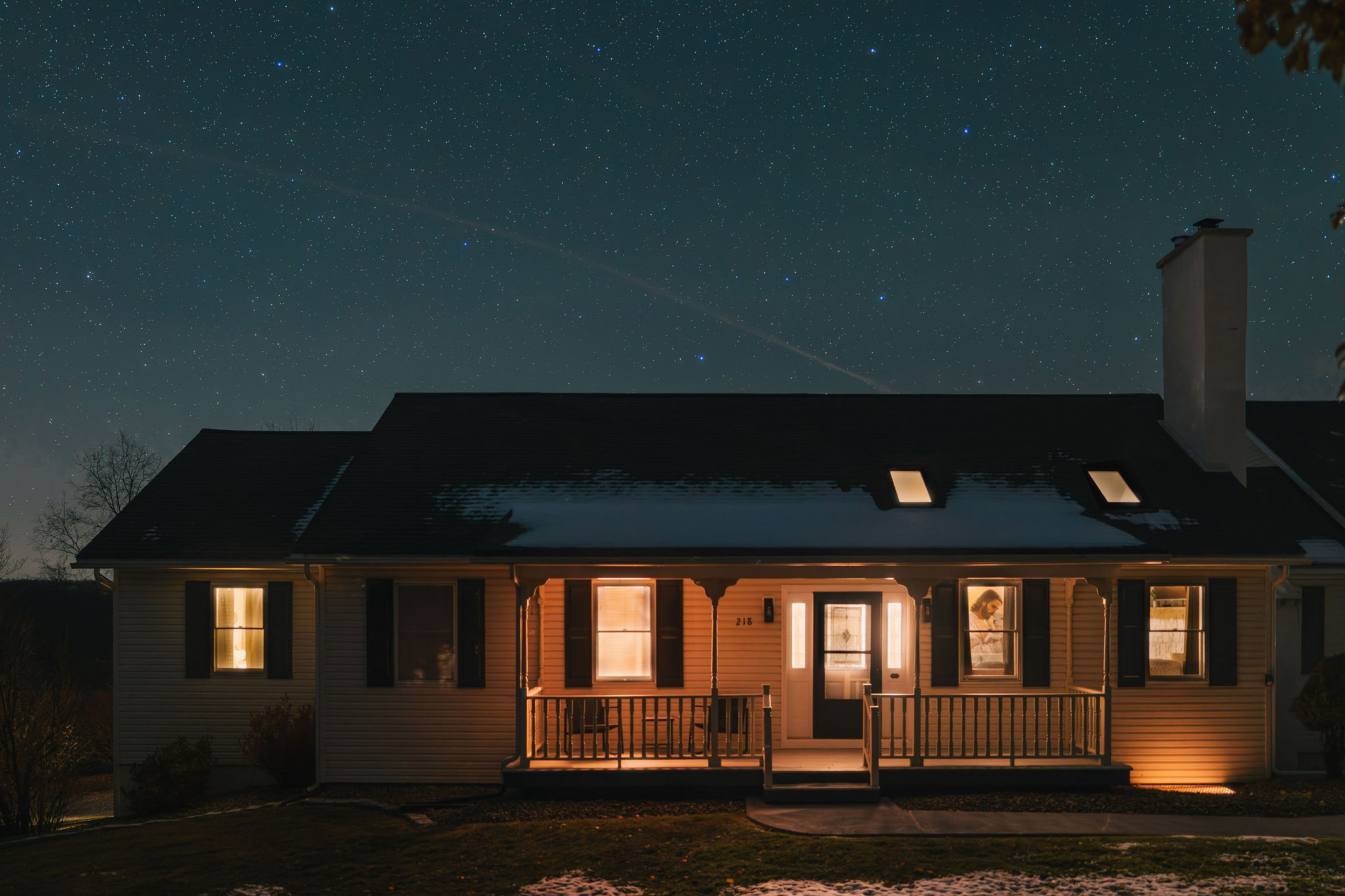 Warm, welcoming front porch illuminated under the Potter County night sky.