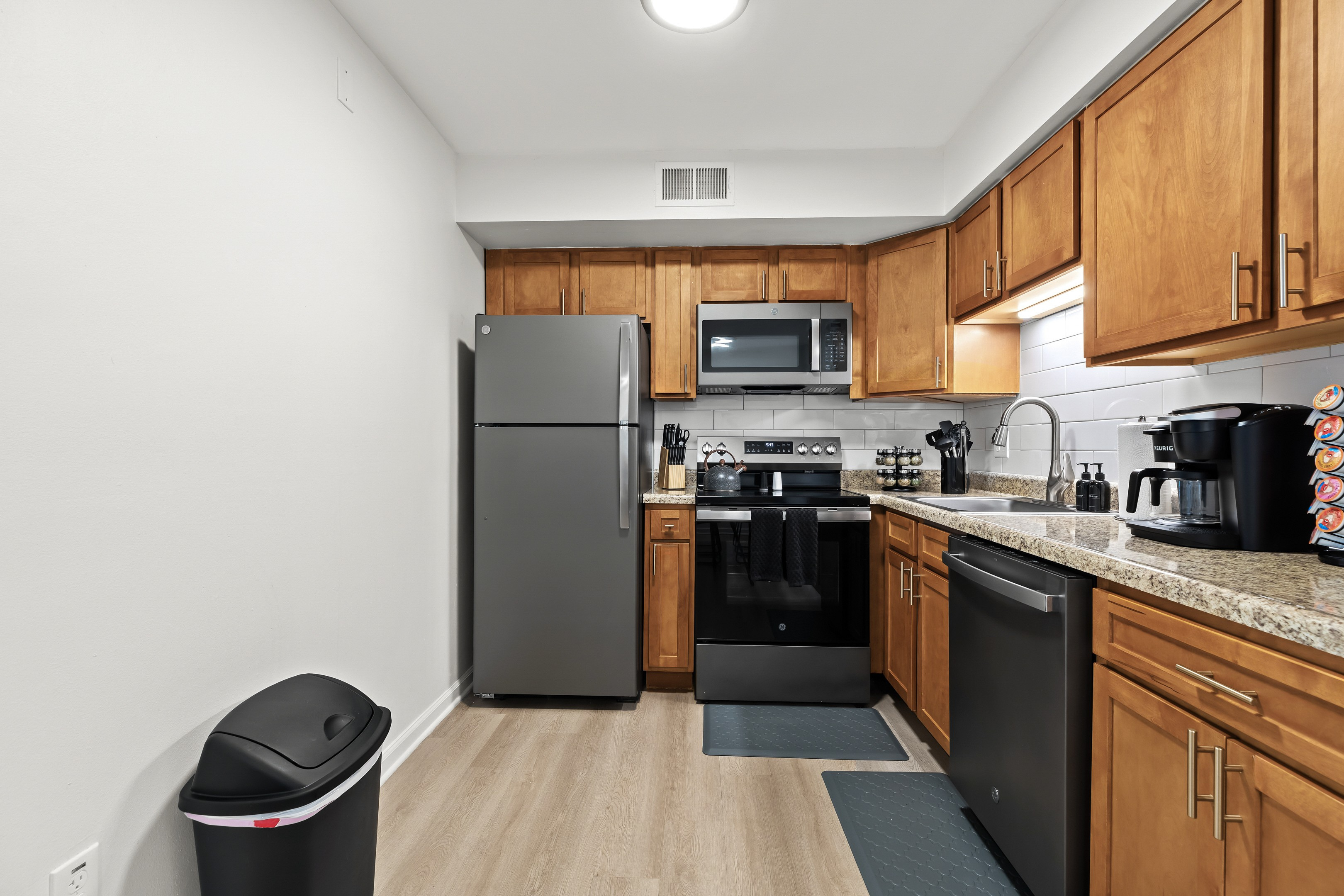 Cook with ease in a kitchen equipped with quality knives, a spice rack, and must-have utensils.