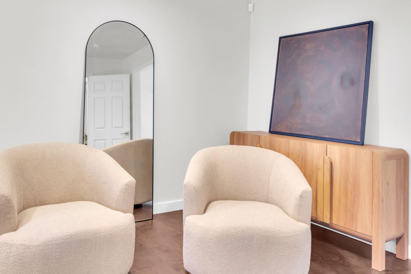 Primary bedroom sitting area with seating for two, creating a comfortable space to relax, read, or enjoy a quiet moment within the suite.