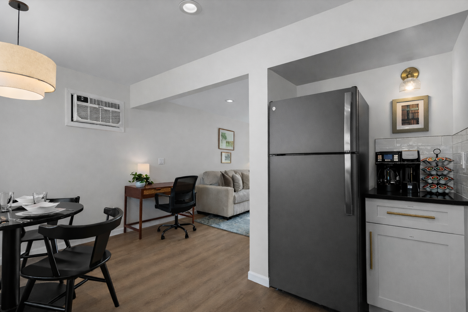 Open kitchen and dining layout with modern appliances, coffee station, and easy flow into the living and workspace areas for everyday comfort.