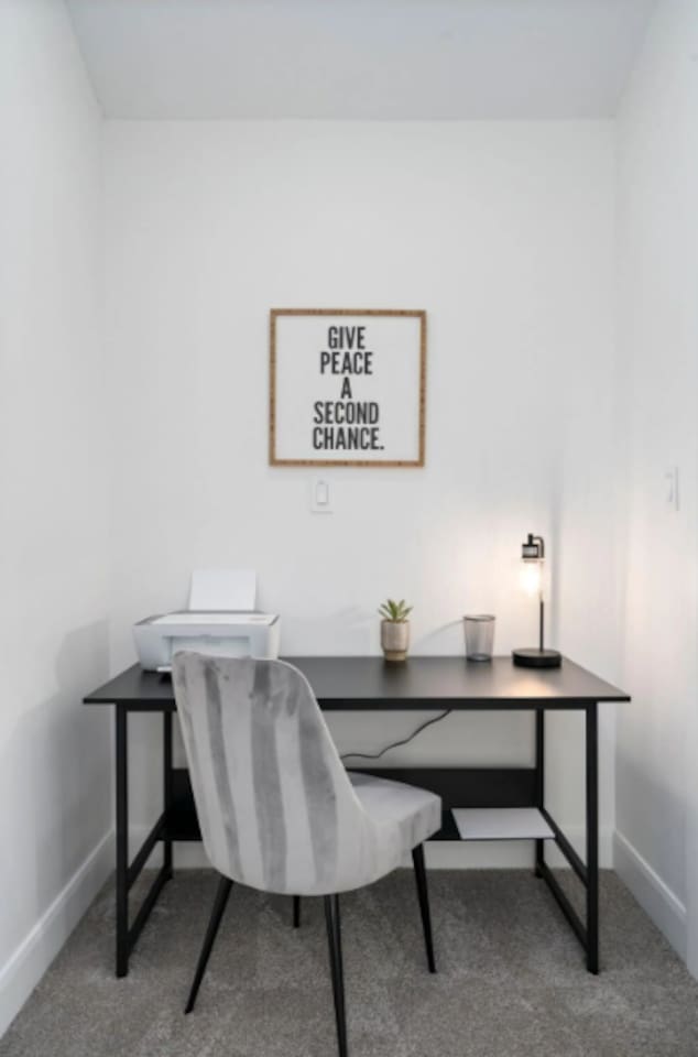 Dedicated office nook with desk, printer, and inspirational décor—perfect for remote work.