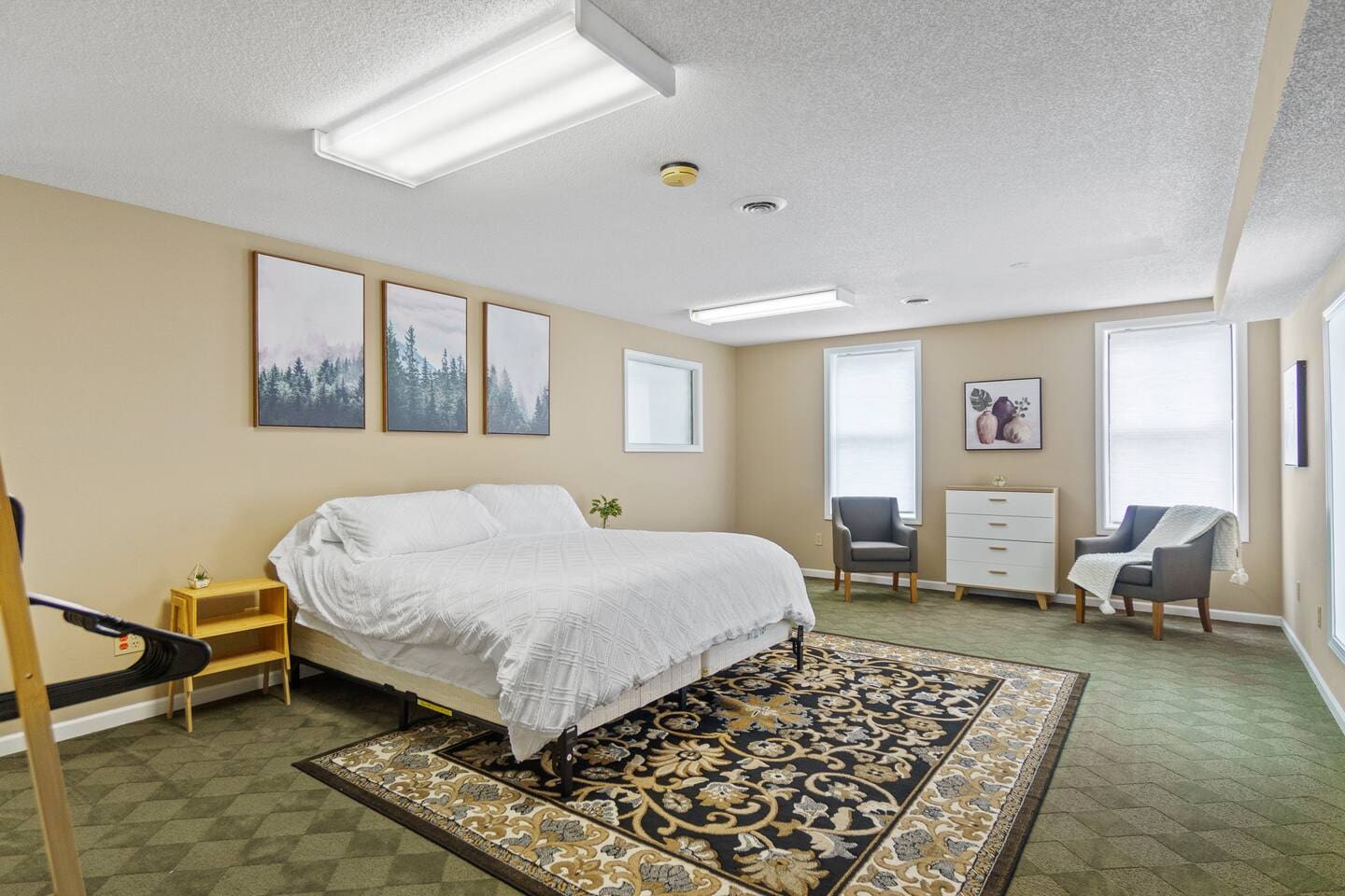 Spacious queen-sized bedroom offering plenty of room for relaxation and comfort, with cozy furnishings for a restful stay.