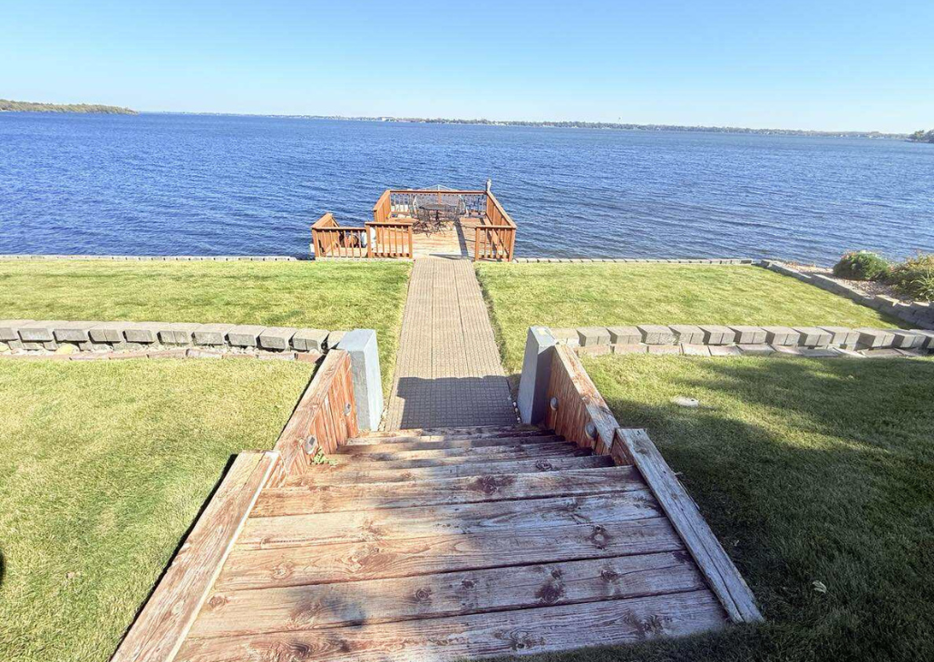 More stairs that goes out to the deck on the water.