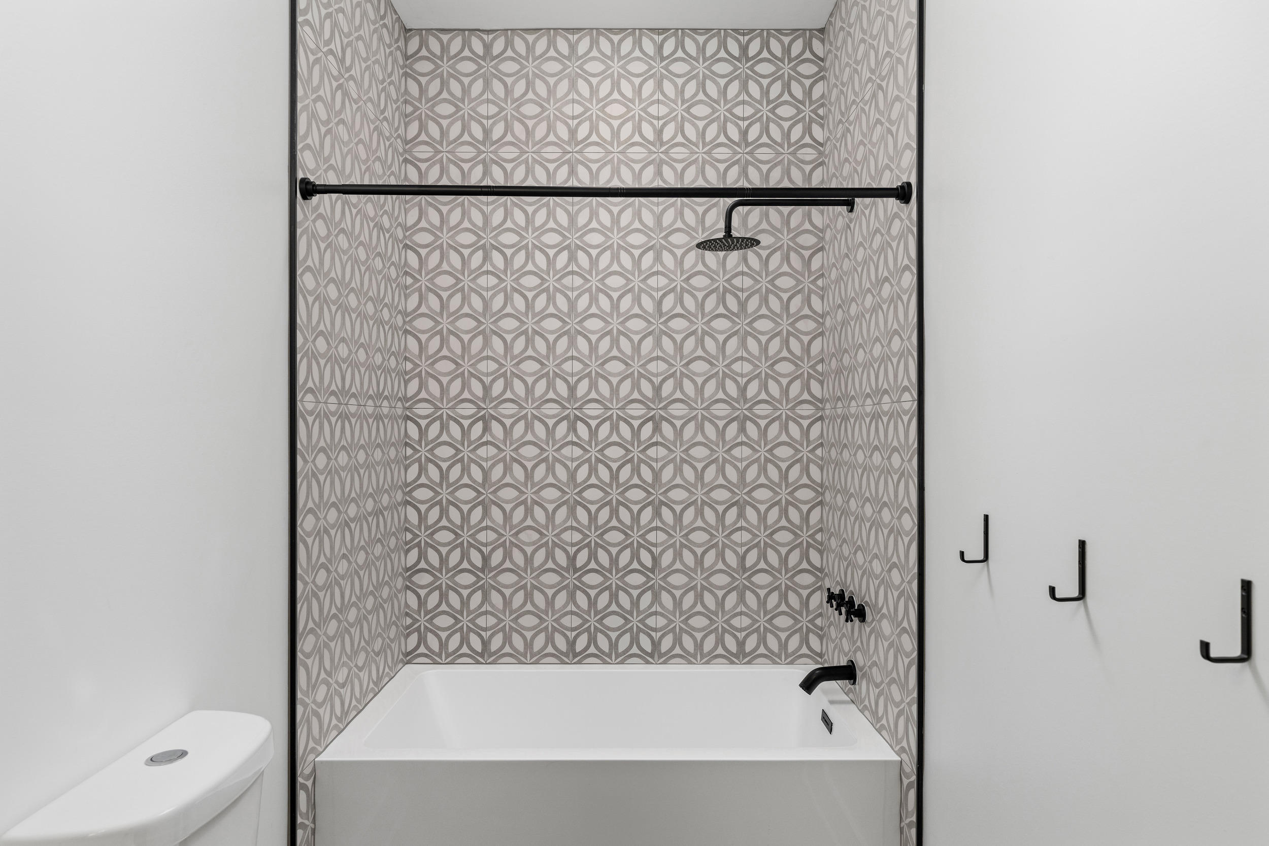 Stylish Bathroom: Unwind in a chic tub, surrounded by artful tile and modern fixtures!