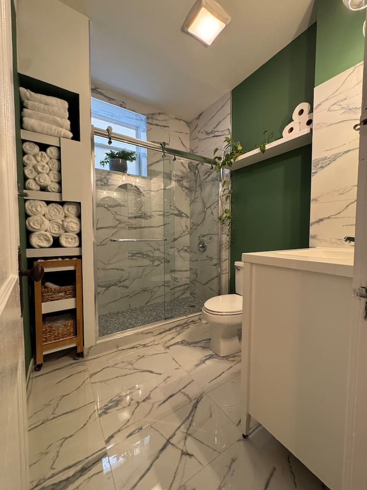 Beautiful bathroom with marble tile designed and modern fixtures.