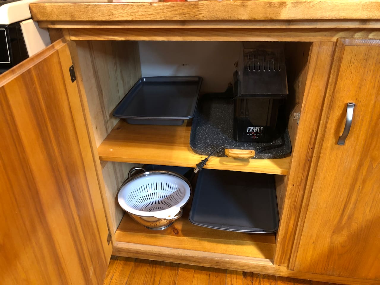 Cake pan, cookie sheets, large 2-burner griddle, air popcorn maker and colanders. 