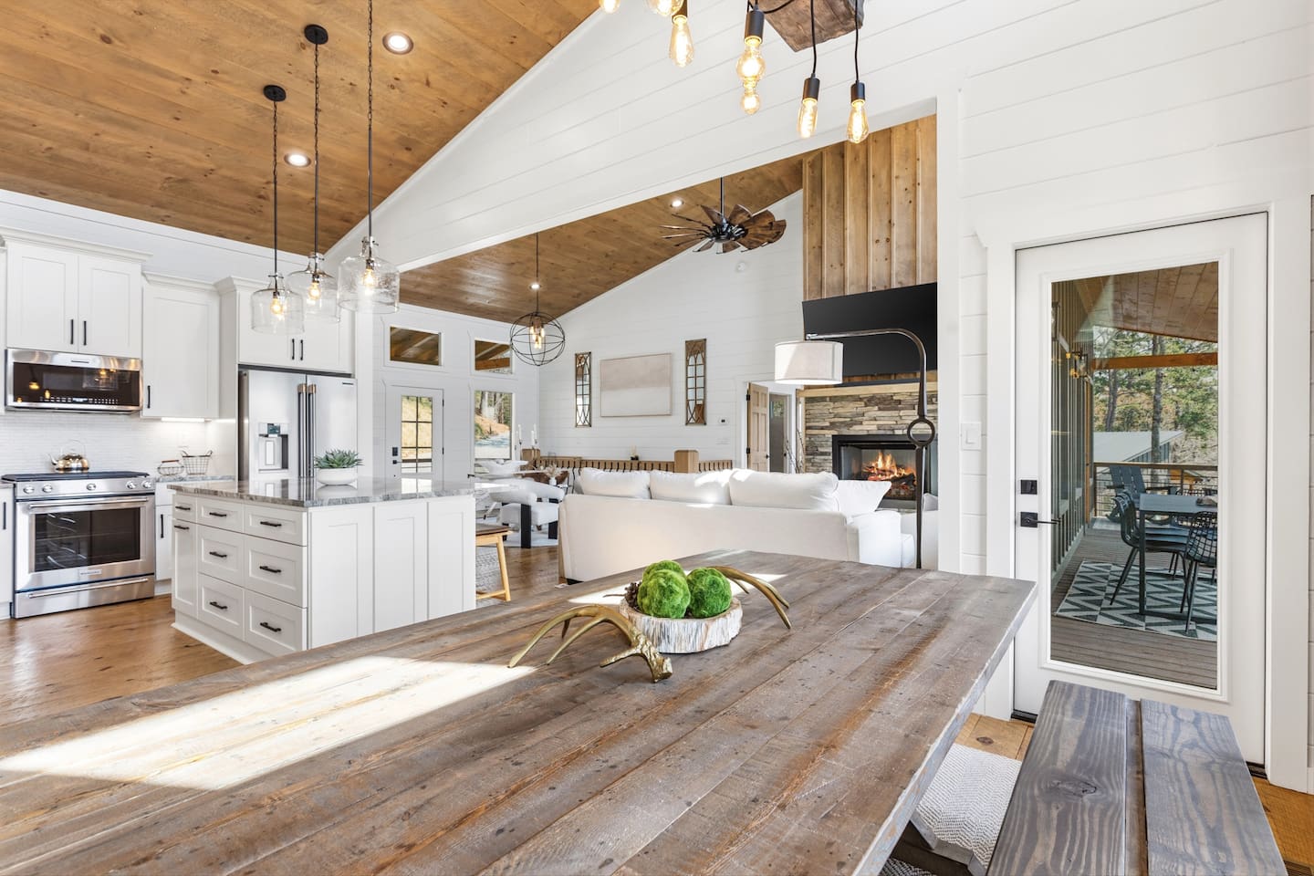 Open to the gourmet kitchen and living room with fireplace, this 8-person rustic farmhouse table is the heart of the home. Perfect for memorable family meals, game nights and effortless entertaining. Three extra stools at the island for more seating.