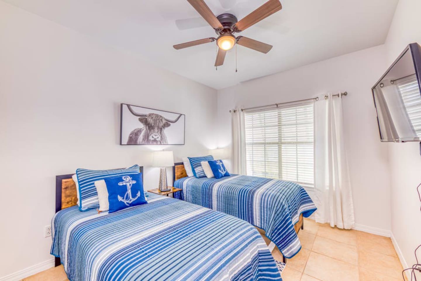 Bedroom Retreat: Bright and airy room with two comfy beds and charming coastal decor!