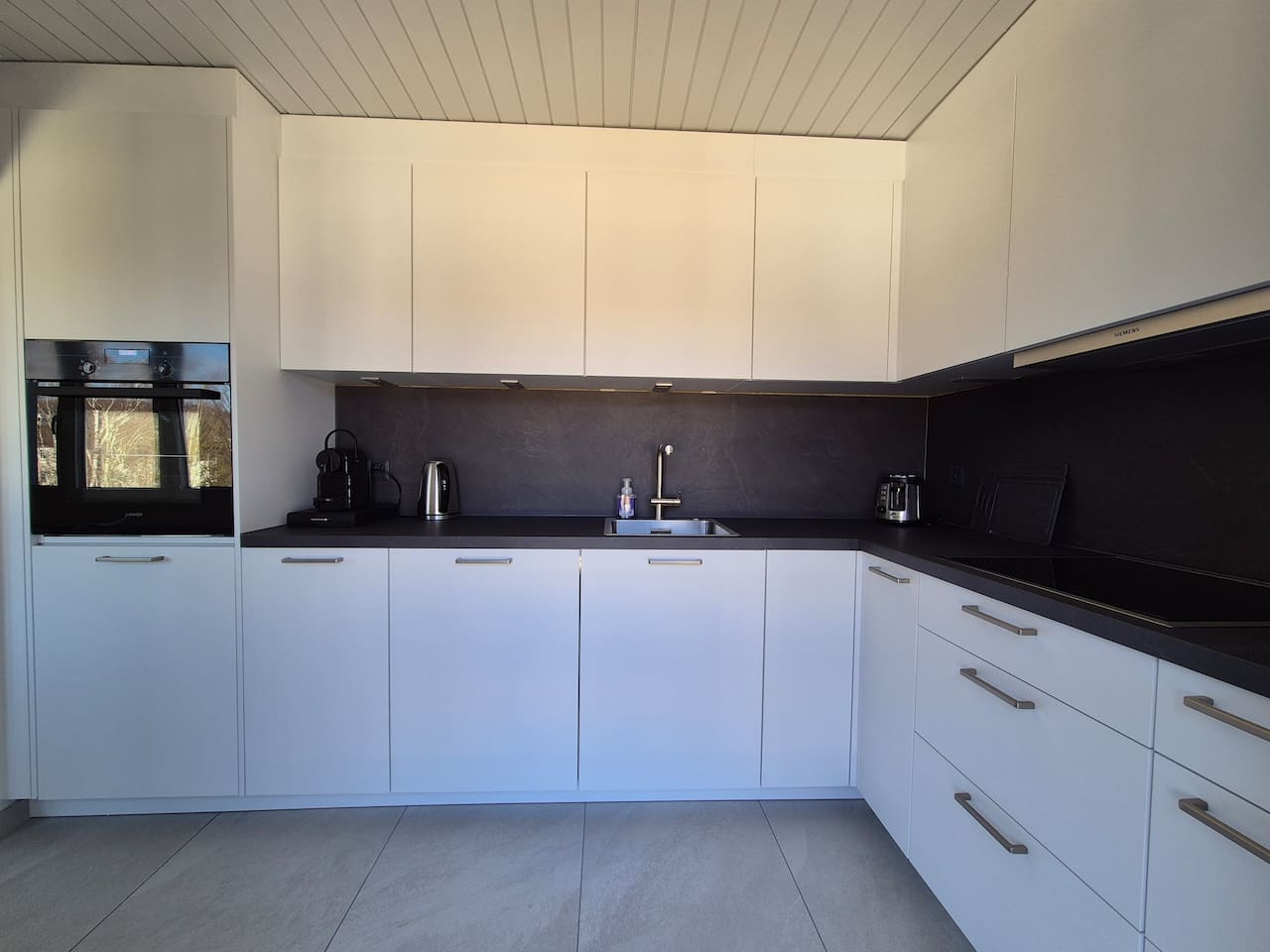 The kitchen is large and has lots of storage space.