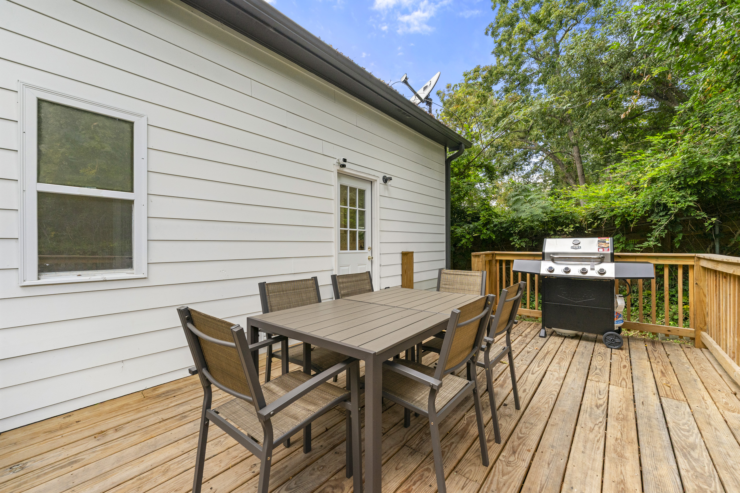 Dine outdoors on the spacious deck surrounded by greenery and fresh air.