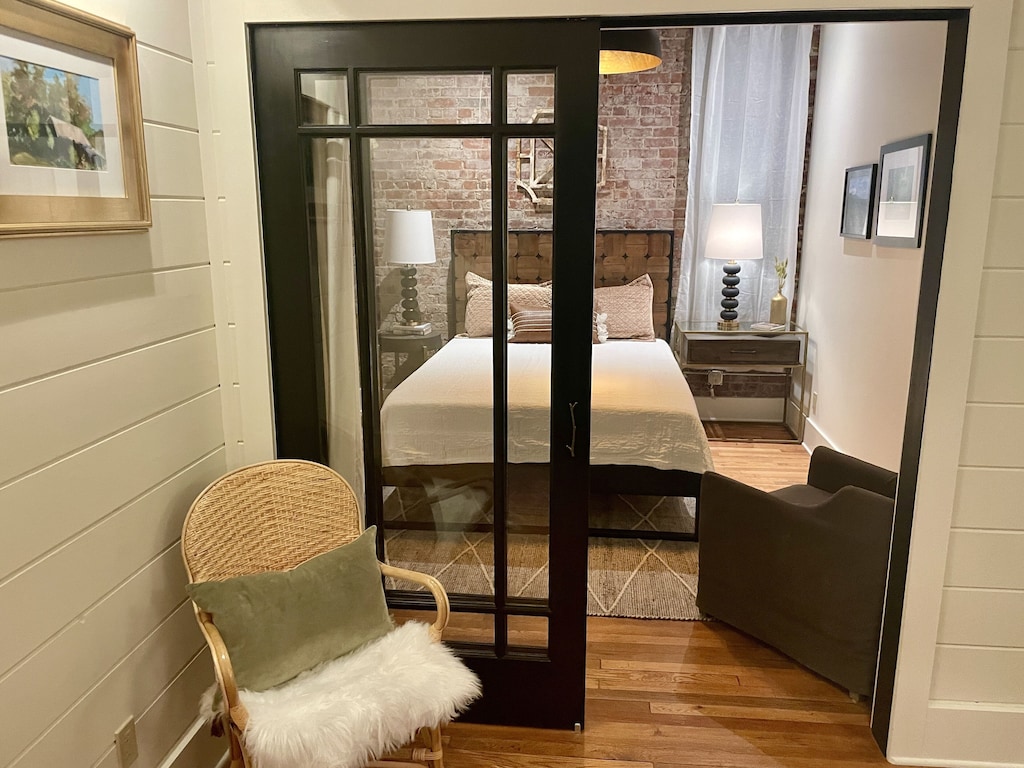 Bedroom #2 with exposed brick and ensuite bathroom