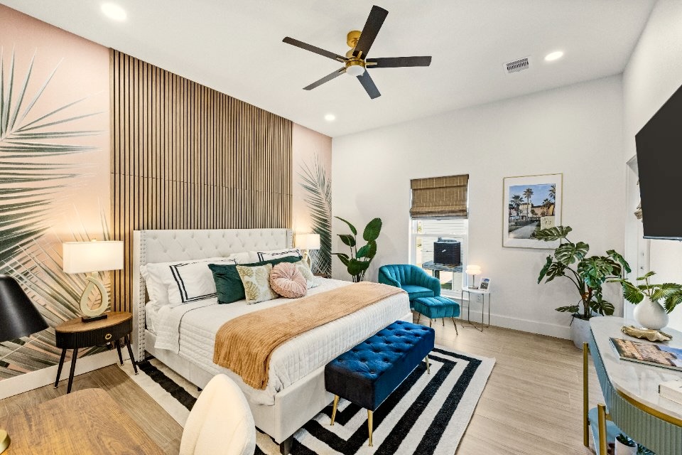 Palms of the Grand Galvez themed primary suite. This first floor king luxurious bedroom includes a desk, direct porch access, ensuite bathroom and a 50" TV.
