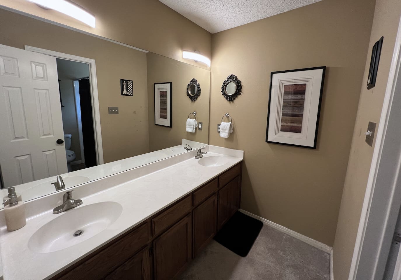 The Hall Bath features a double sink vanity.  Shower Room Adjoins.  Towels, Soaps and Toilet Paper Provided.