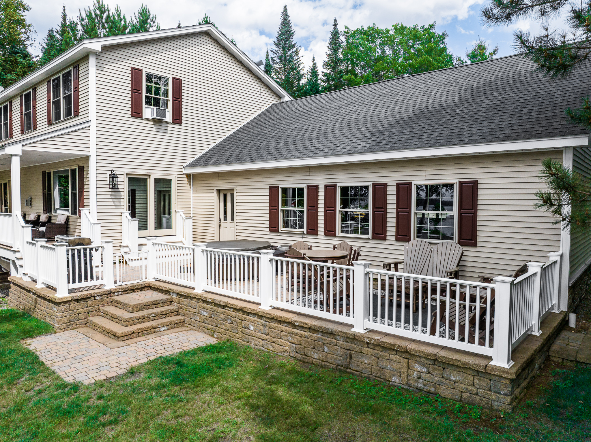 Comfortable seating area on the patio with hot tub, fenced in.