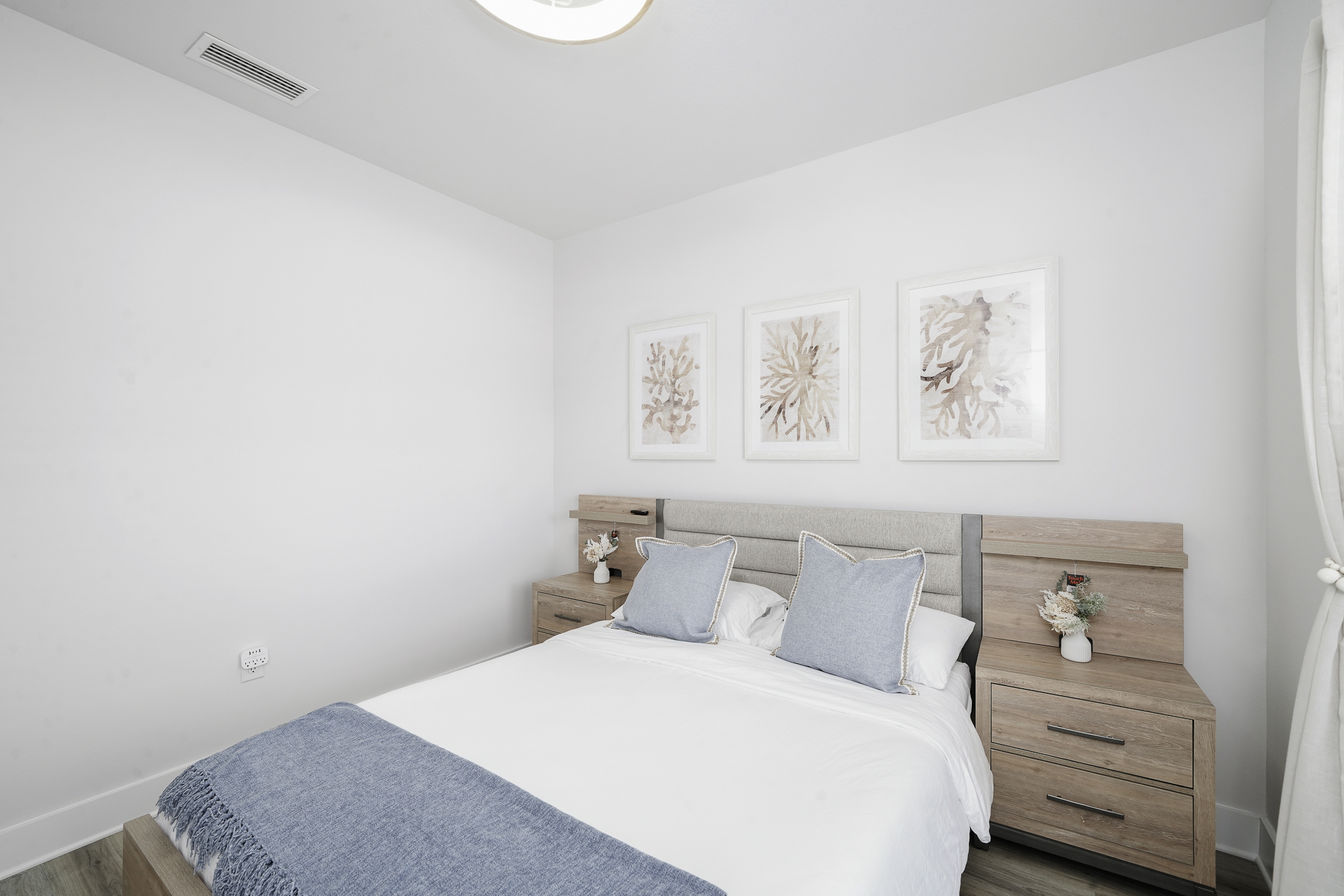Bedroom 2: Bright Queen bedroom, comfy linens, ceiling fan, elegant bedside lamps, wall art, and Smart TV.