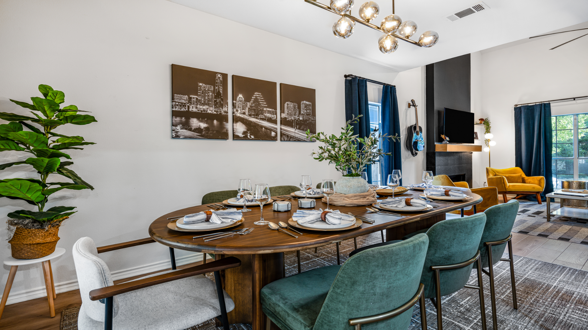 Step into your groove! Dine under a modern chandelier, with cityscape art for urban flair and lush greenery for a fresh vibe. Gather, savor great food, and enjoy even better company!