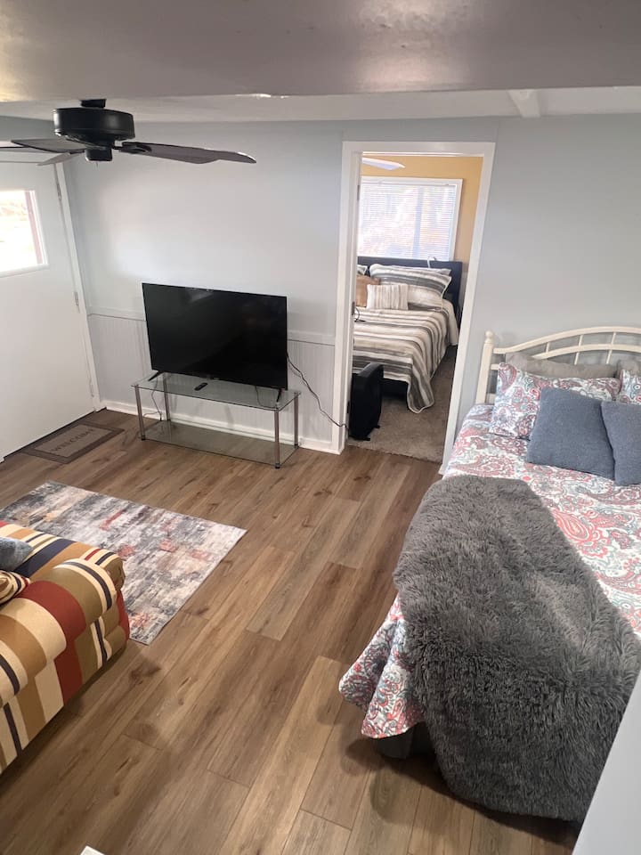 The third bedroom is a converted common area that has been set up as a comfortable sleeping space. While it does not have a traditional enclosed bedroom layout, it provides a cozy and functional area ideal for additional guests. 
