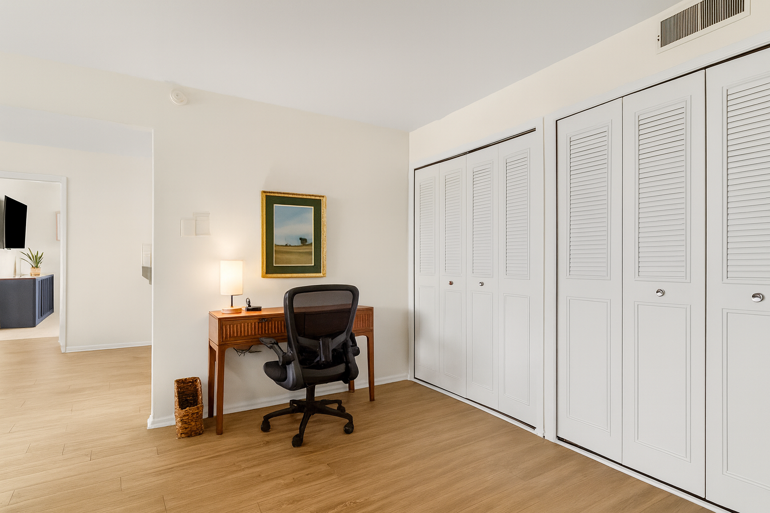 Well-lit workstation with desk, ergonomic chair, and charging access—ready for productivity.
