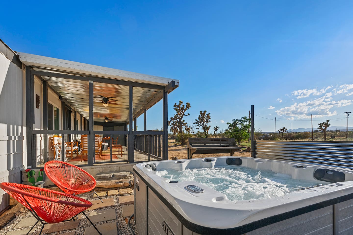 Hot tub with a beautiful view, steps from the expansive porch