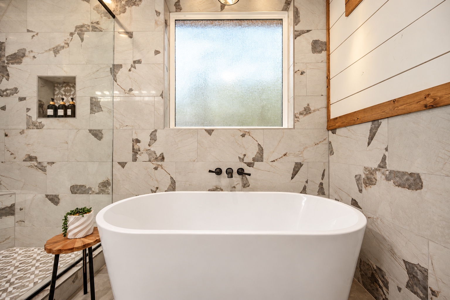Slip into the soaking tub and savor a quiet moment beneath soft natural light.