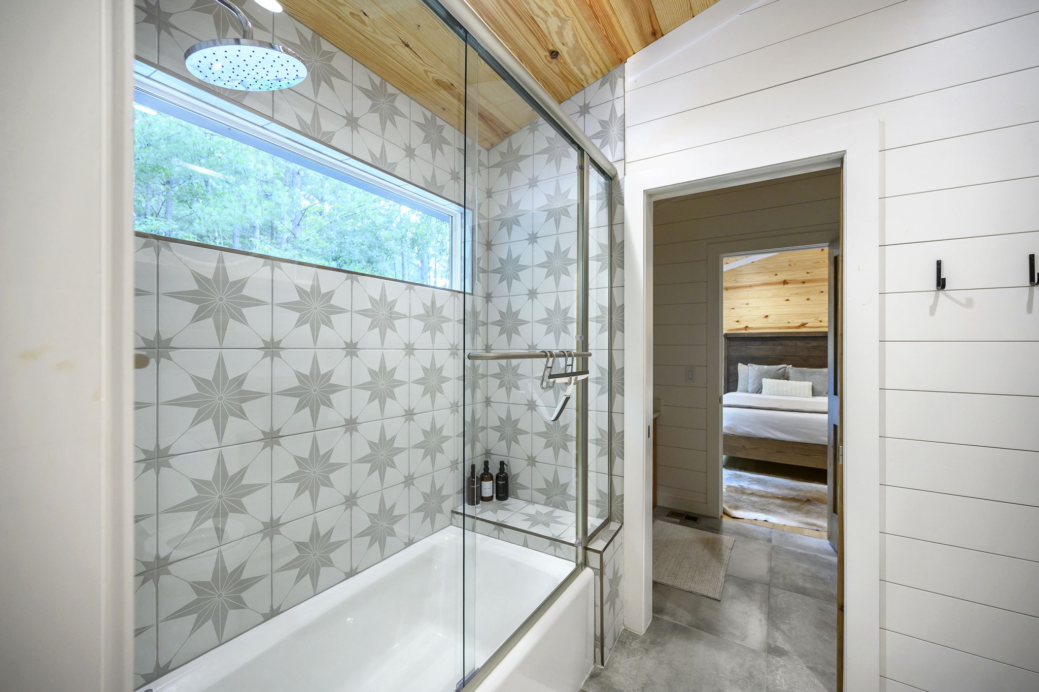The shared full bathroom offers a cozy, spa-like feel with luxury finishes, warm design details, and everything guests need to feel comfortable and refreshed.