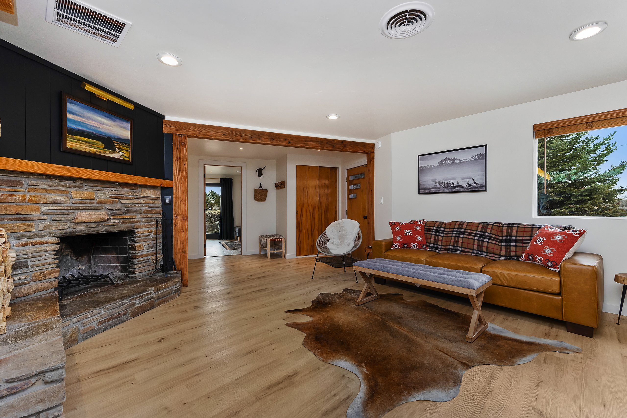Living room with a cozy fireplace and canyon views out the windows