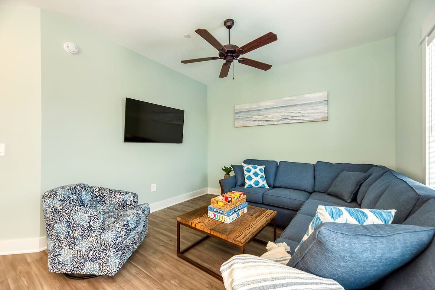 Open and airy living room designed for family relaxation with a comfortable queen sleeper sofa.