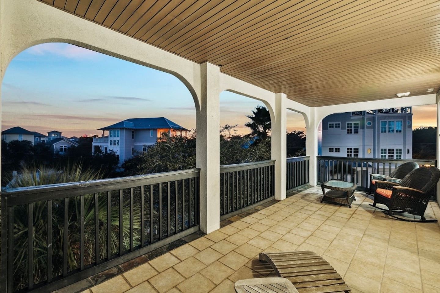 Private third-floor balcony off the king bedroom, featuring comfortable rocking chairs and peaceful neighborhood views for morning coffee or sunset relaxation