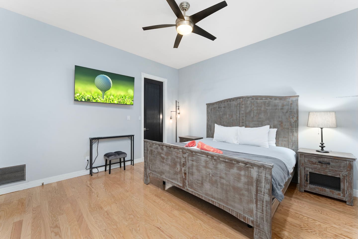 Unwind in this cozy king bedroom featuring rustic wood furnishings, soft linens, and warm ambient lighting.