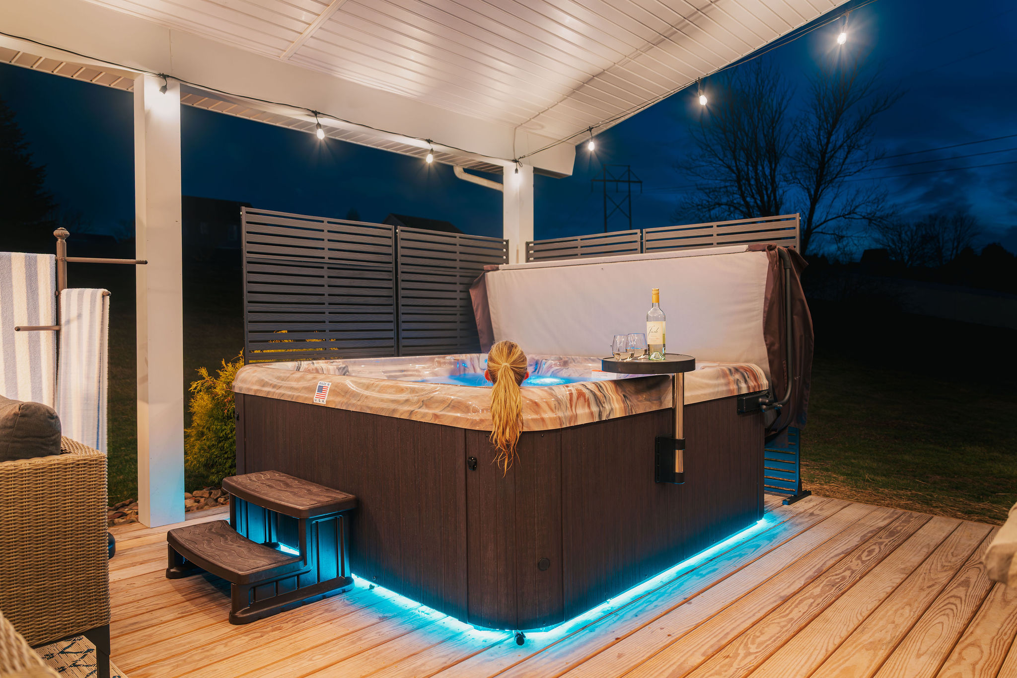 Relax under the covered patio with a private hot tub and outdoor lounge — perfect after game day, hiking, or exploring Bellefonte.