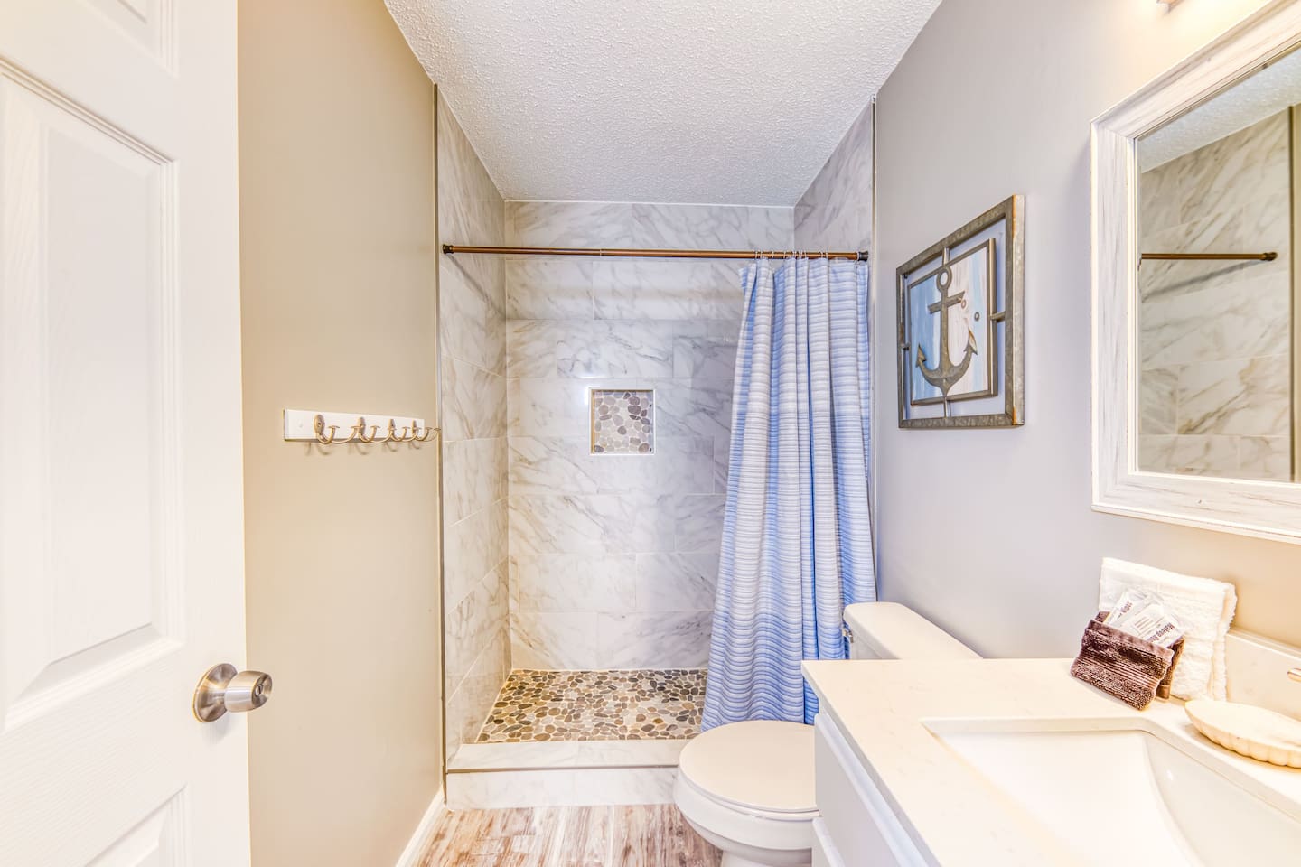 Bathroom Bliss: Luxurious tiled shower and nautical decor make every wash feel like a retreat!