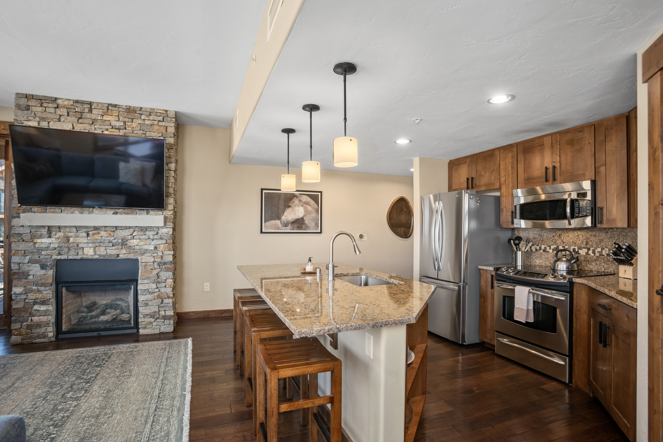 Kitchen with Living Room Fireplace in the background