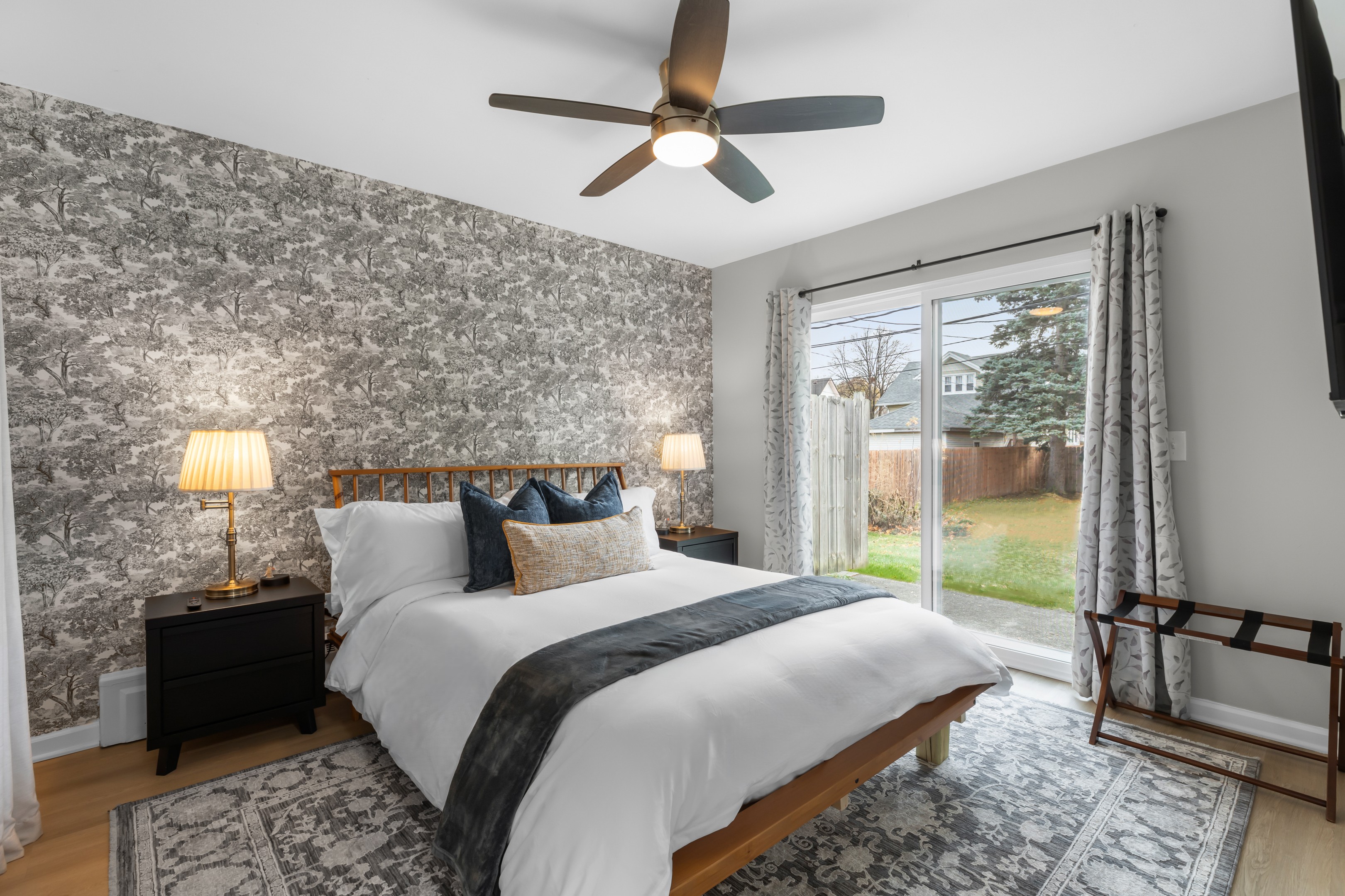 A stylish bedroom with a modern bed and a ceiling fan that adds a touch of elegance.