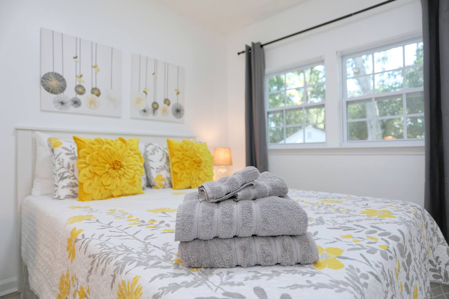 Unwind in the third bedroom, featuring a comfortable queen bed, a convenient desk for work or planning your day, and extra pillows for added comfort.