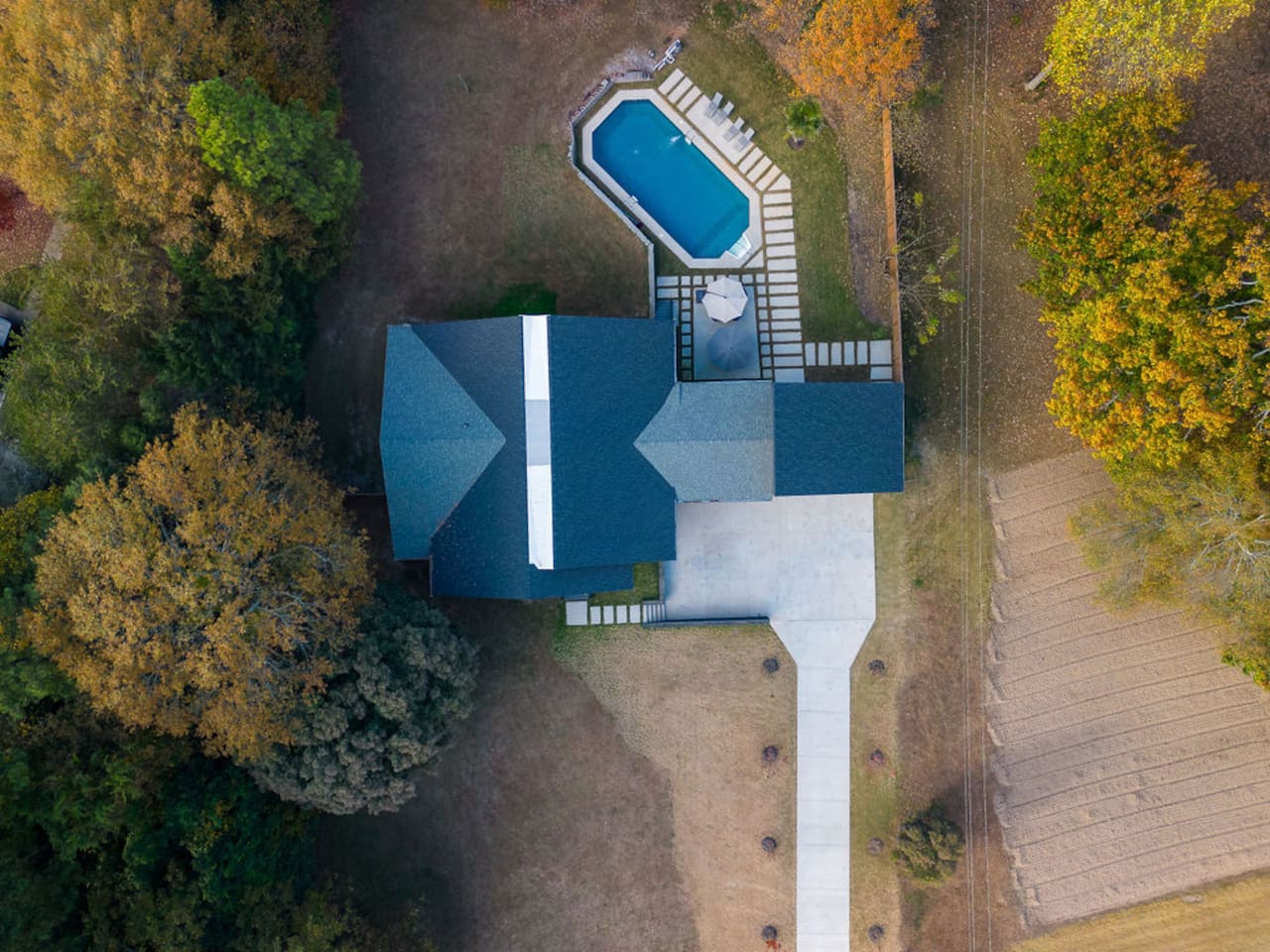 Stunning aerial view of the property, showcasing the spacious grounds, beautiful landscaping, and the perfect layout of the home in its surrounding environment.