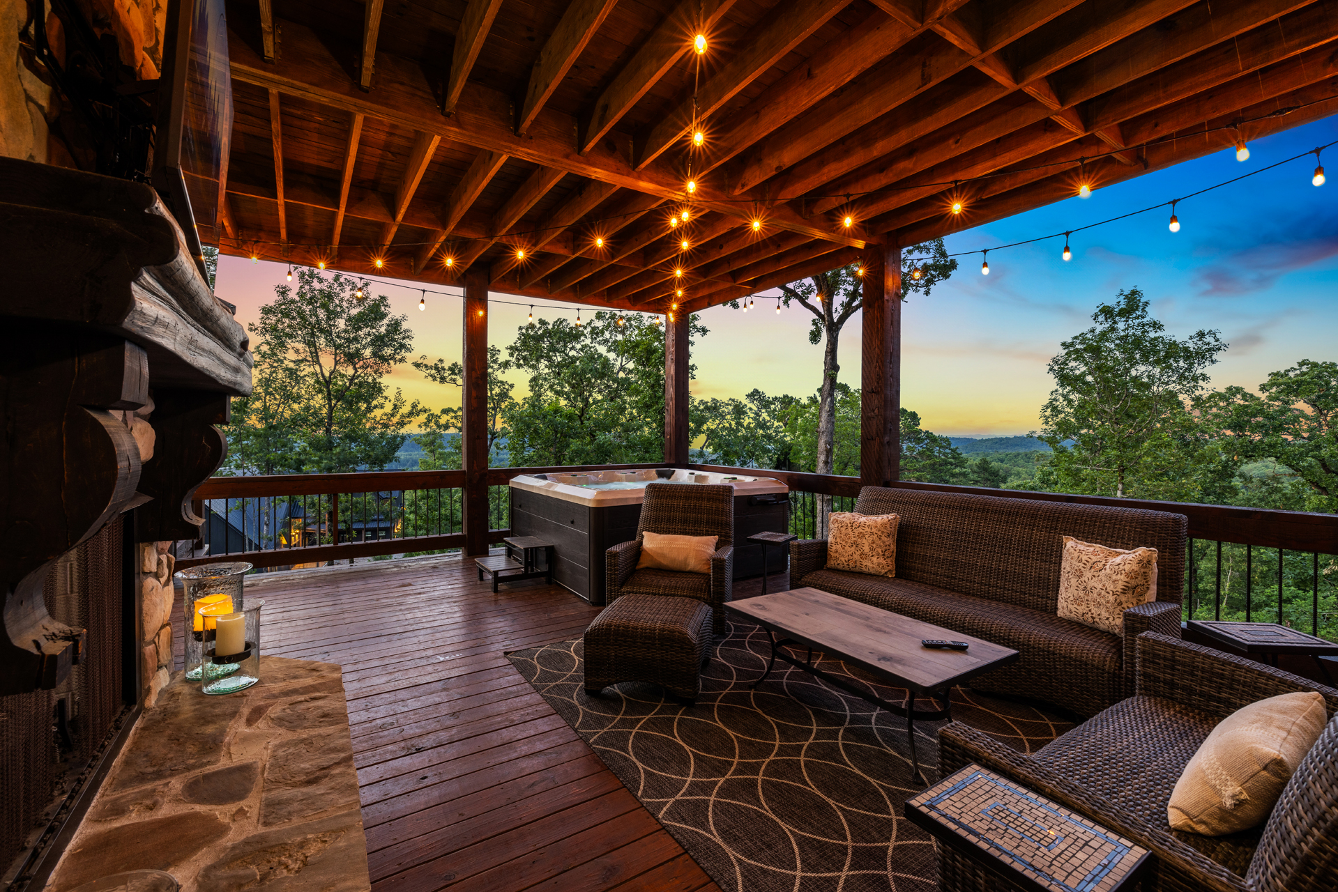 Luxury outdoor living space with string lights, cozy seating, and mountain ambiance