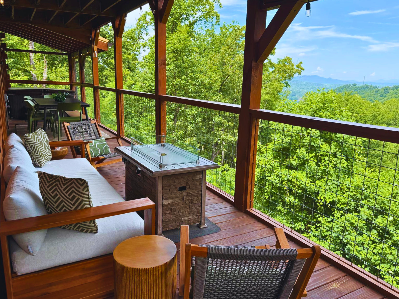 Enjoy the comfortable outdoor setting in the main deck with hot tub, dining table, seating area around the fire pit, Weber propane grill and outdoor games, perfect for outdoor entertainment
