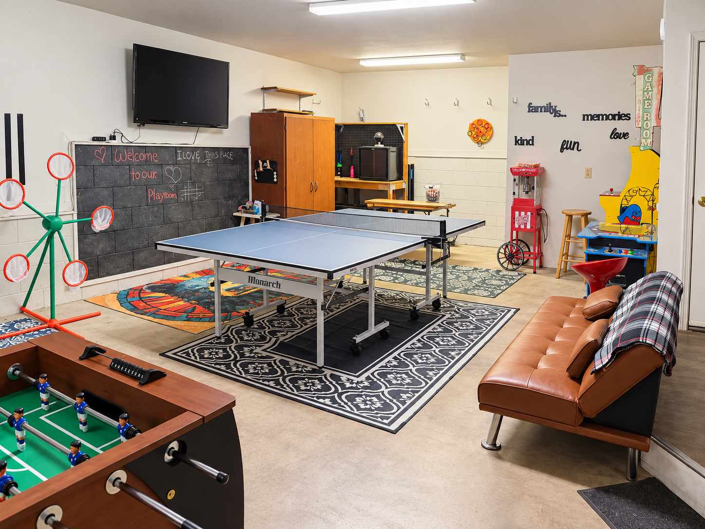 Game room with ping pong, foosball, arcade games, TV, and plenty of space for group fun.