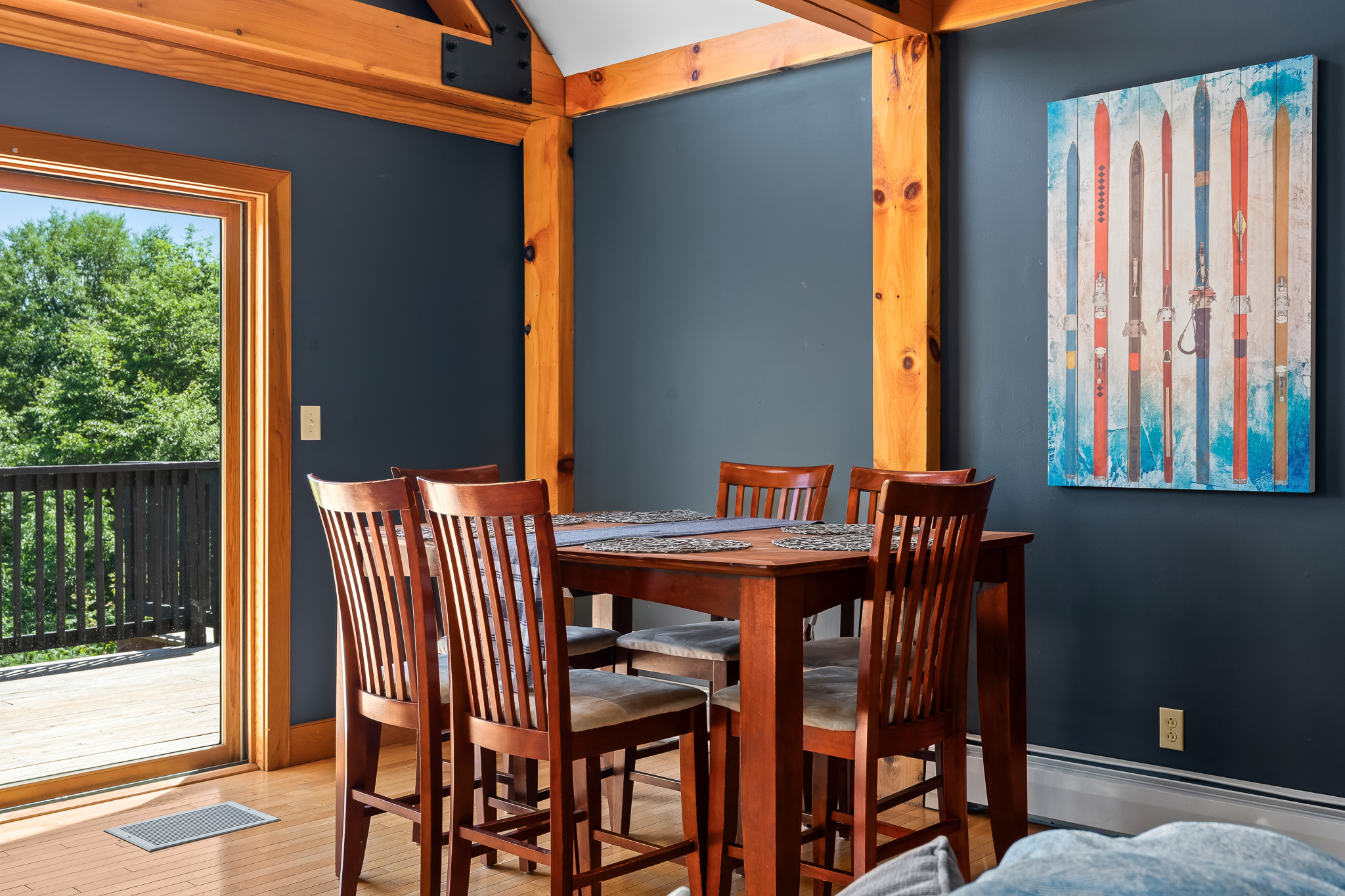 Share slow meals and mountain stories in a cozy dining nook framed by rustic charm and peaceful views.