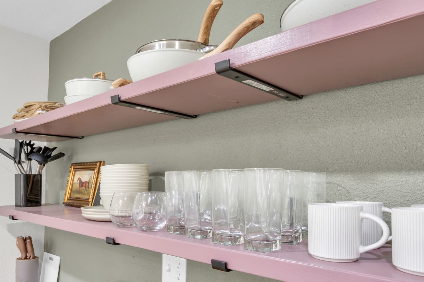 Everything you need for dining in; modern kitchen with electric range, oven, microwave, Keurig coffee maker, and fully supplied cookware and glassware.