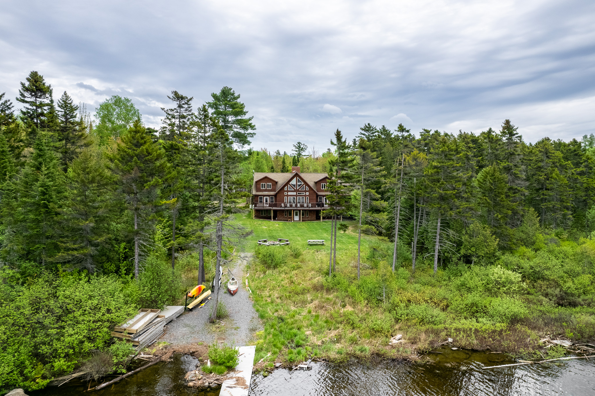 Huge backyard to play games like corn hole with custom corn hole boards, enjoy a fire in one of the 2 fire pits overlooking the lake, use kayaks and paddle boards, swim, fish, boat, and enjoy the way life should be!